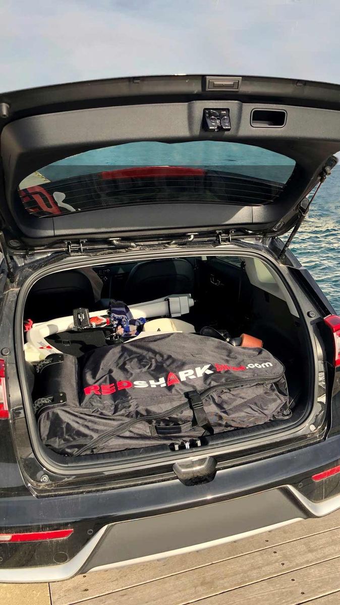 Red Shark waterfiets opgeborgen in een tas in een gewone autokofferbak